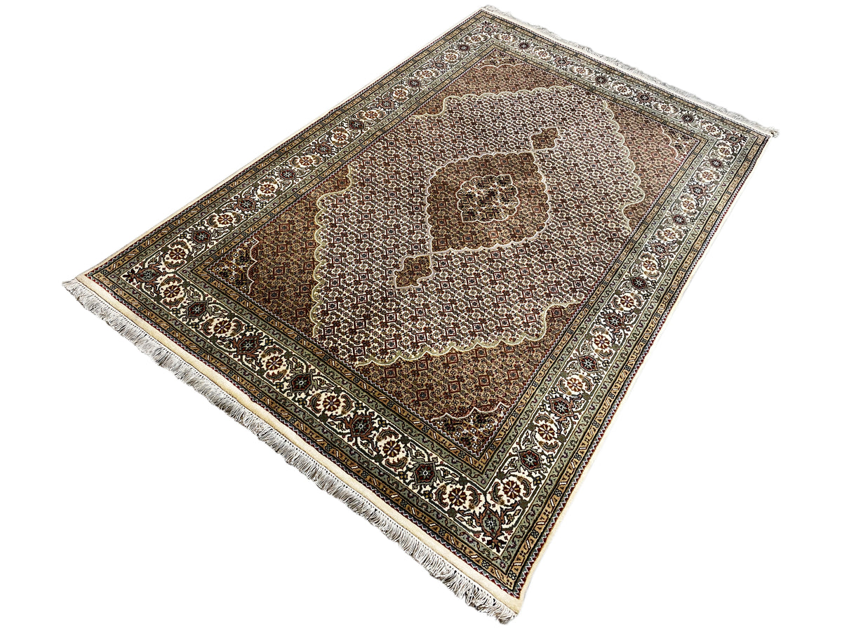Indo Tabriz rug with fringes, diagonal view, brown border and cream pattern