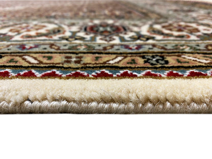 Indo Tabriz carpet detail: pile and border pattern with fringes, cream-colored background