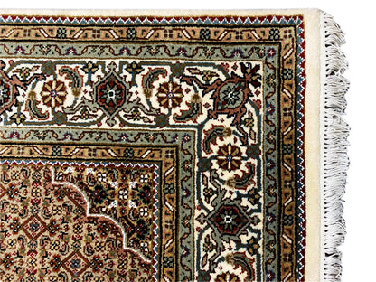Indo Tabriz rug corner detail with fringe, floral ornaments in cream and dark brown