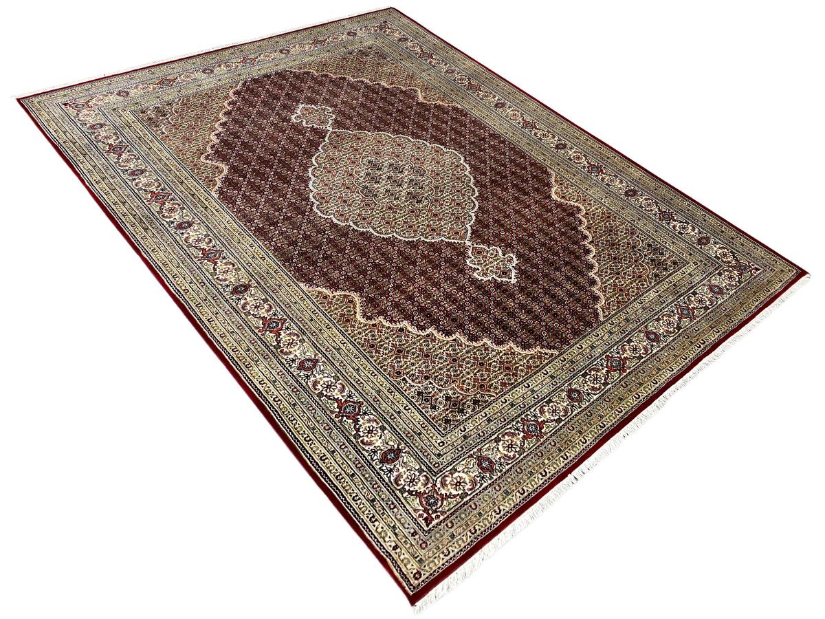 Indo Tabriz rug, diagonal with a red background, patterned borders, and a central medallion
