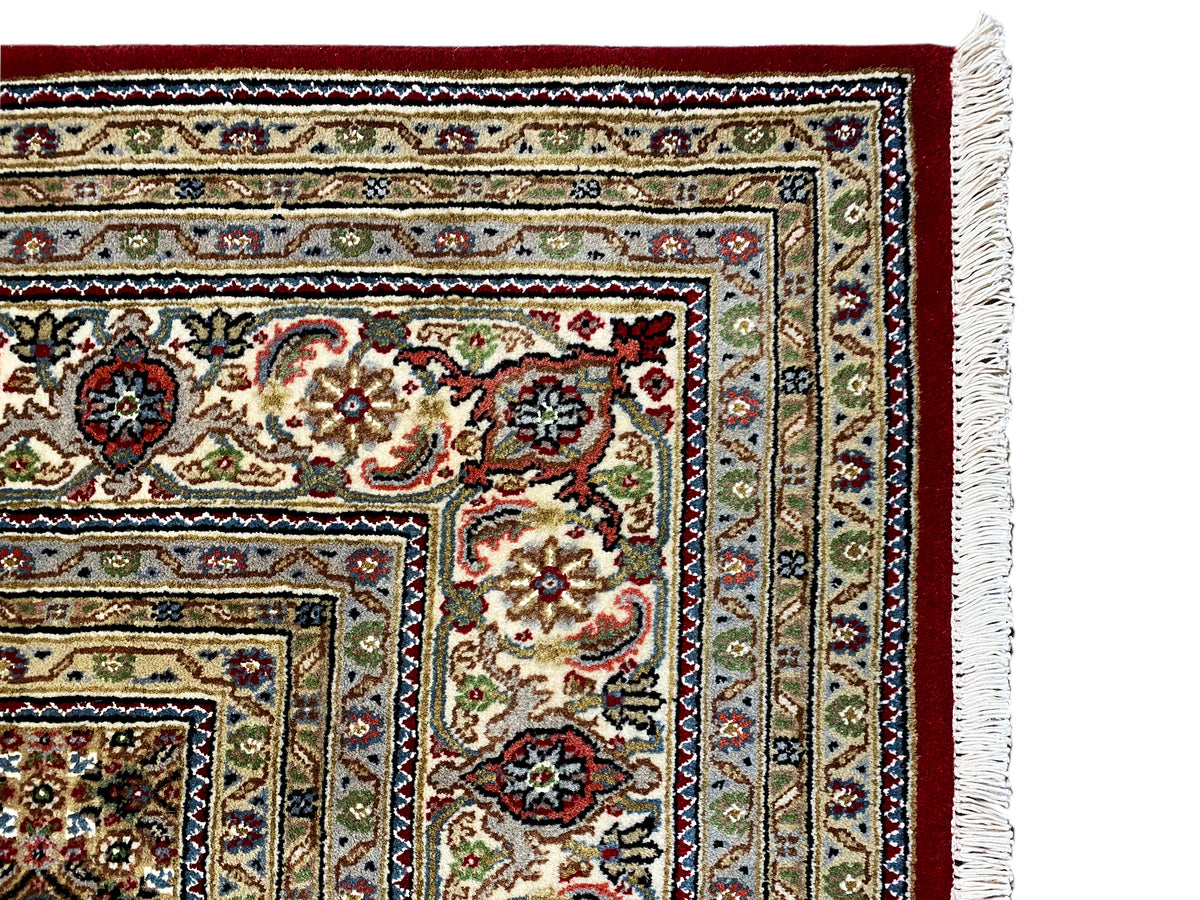 Indo Täbriz carpet detail of the side border with fringe at the right edge