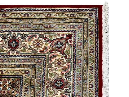 Indo Täbriz carpet detail of the side border with fringe at the right edge