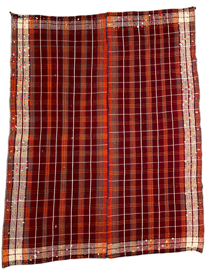 Rug with a red checkered pattern, beige border, and uniform grid structure