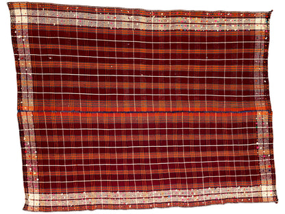 Rectangular rug with a wide border at the bottom and a red checkered grid with beige stripes