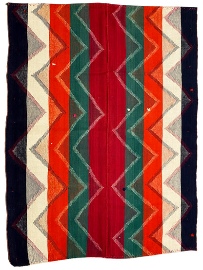 Rug with an even zigzag stripe pattern in red, green, orange, beige and dark blue