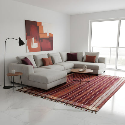 Reddish-brown carpet in the living area with a bound edge and beige borders