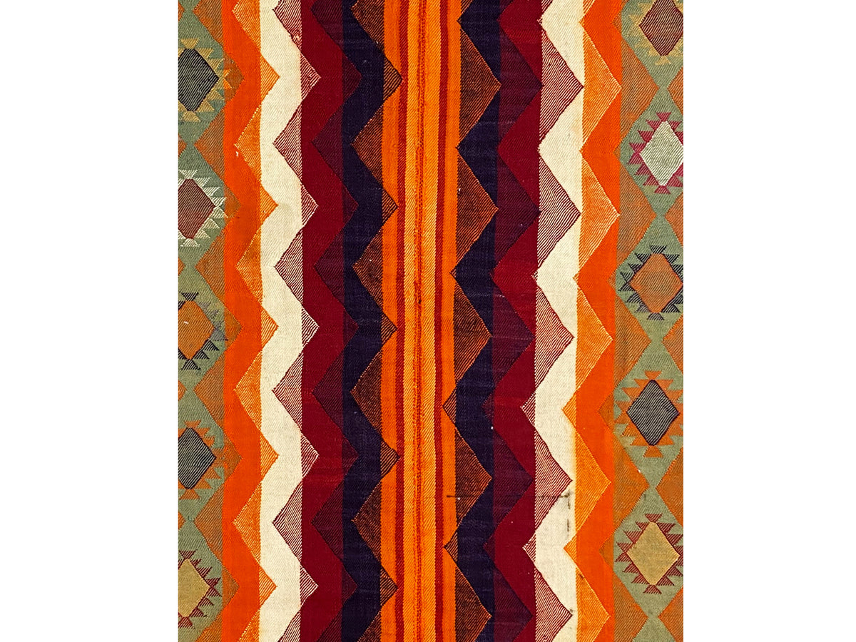 Rectangular jajim rug with a zigzag pattern in orange, dark blue, and cream