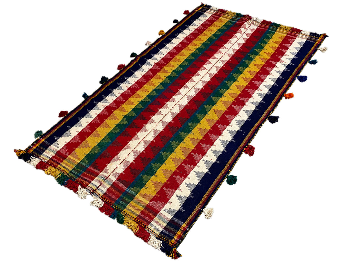 Folded Jajim rug with diagonal stripes and colorful tassels