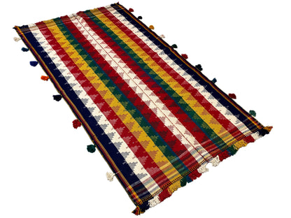 Jajim rug from an overhead angle: multicolored stripes, tassels at the corners