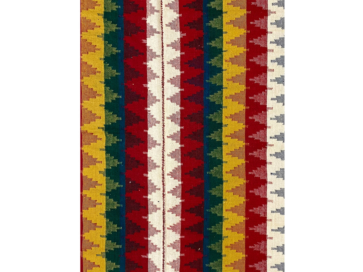 Detailed view of the Jajim rug with stripes in red, yellow, green, blue, and white