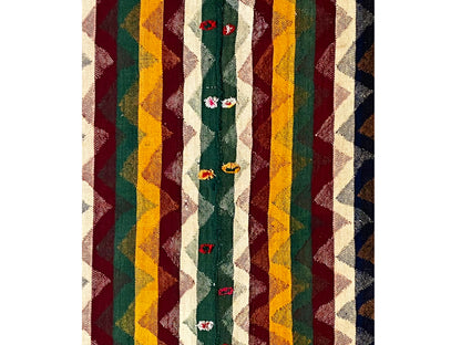 Close-up of a Jajim rug with striped colors and embroidered floral motifs