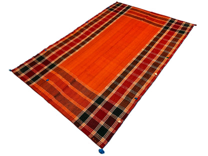 Jajim rug in red-orange and dark brown: diagonal diamond-patterned stripes, corners with blue tassels