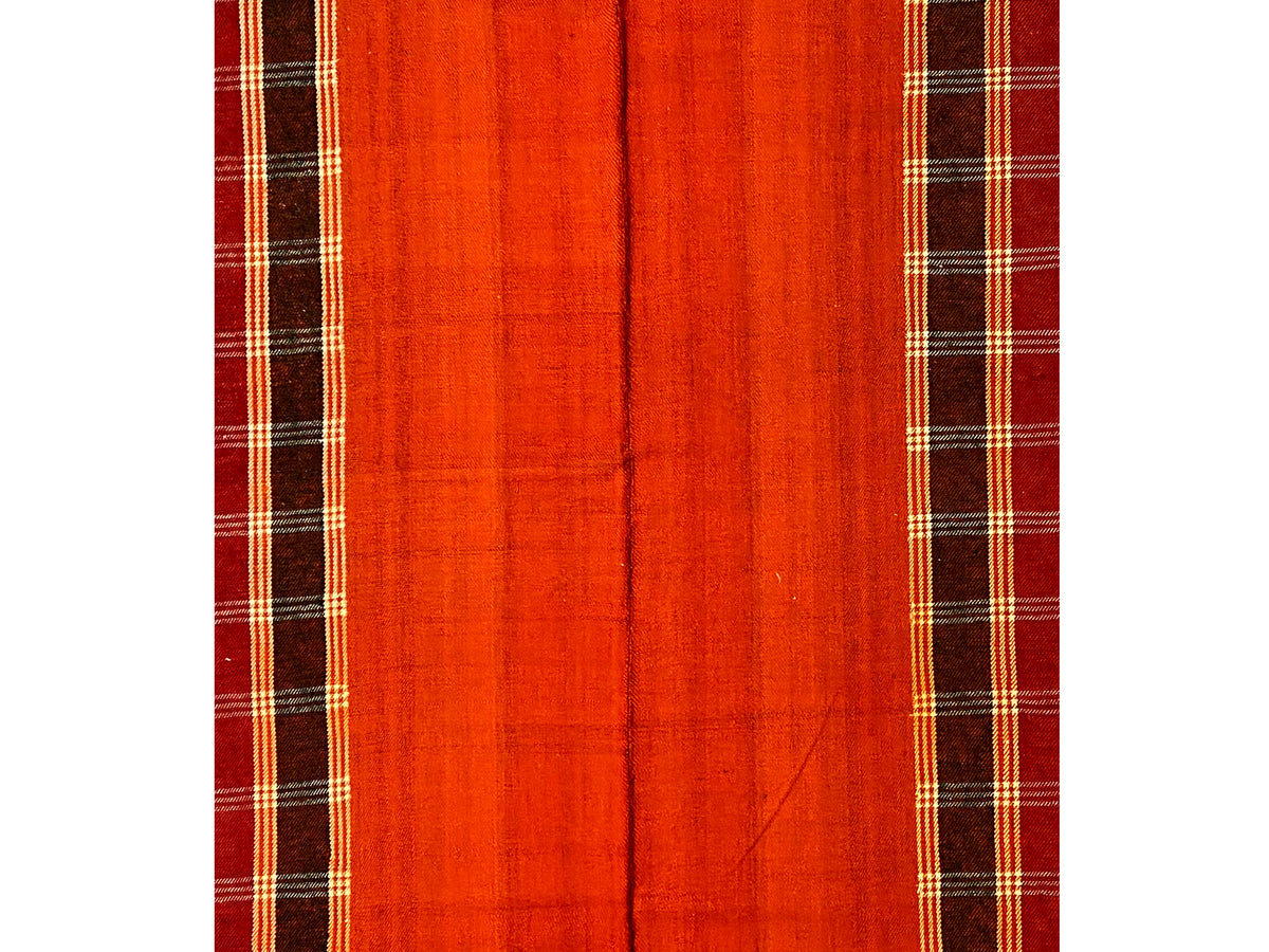Close-up: Jajim rug field in red-orange with a dark linear grid and checked border