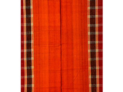 Close-up: Jajim rug field in red-orange with a dark linear grid and checked border