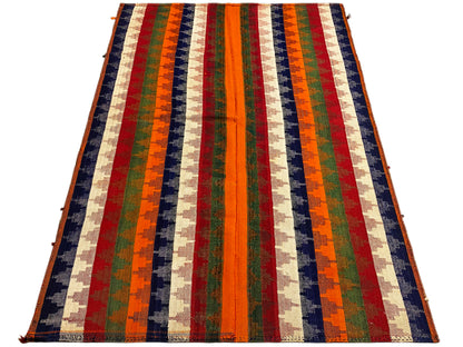Rug with multicolored diagonal stripes, spread at an angle; orange, green, blue, red, beige