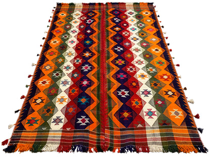 Large-format jajim rug with an orange border and zigzag patterns, fringes