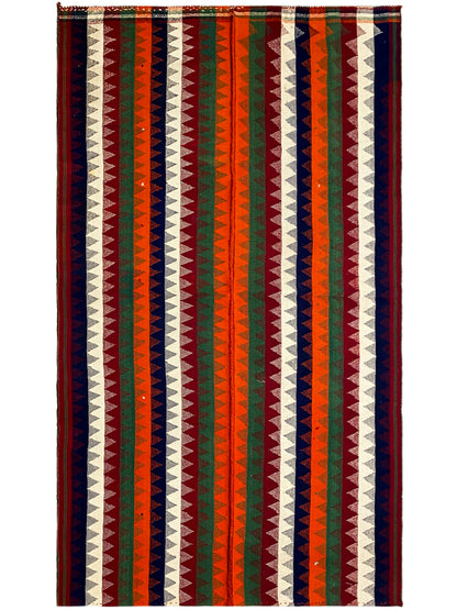 Rectangular jajim rug with zigzag and striped patterns in green, red, blue, and cream tones