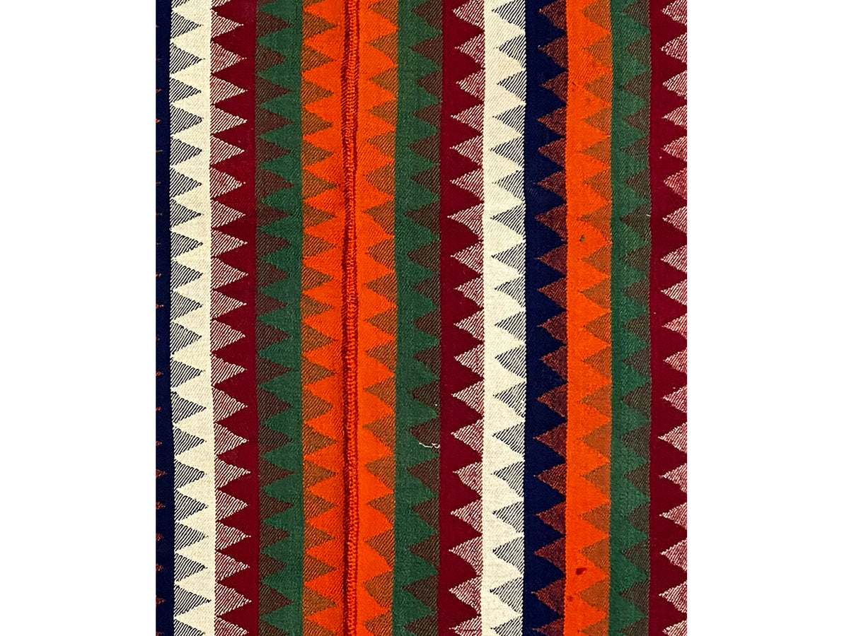 Close-up: vertical striped pattern in orange, green, blue, red, and cream