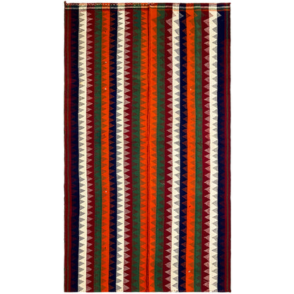 Rectangular jajim rug with a zigzag and striped pattern in green, red, blue, and cream