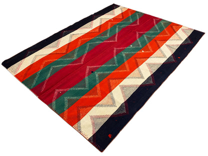 Rug with a rhombus-cut design and zigzag stripes in red, green, orange, beige, and dark blue