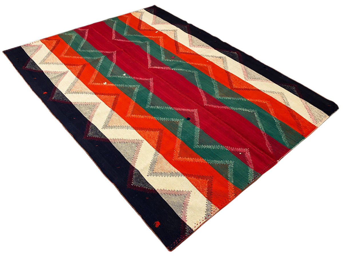 Rug with zigzag stripes and a central stripe in red, green, orange, beige, and dark blue