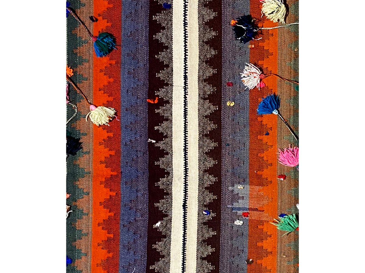 Close-up: carpet with vertical stripes and colorful floral ornaments
