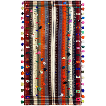 Colorful jajim rug with multicolored stripes and tassels along the edges