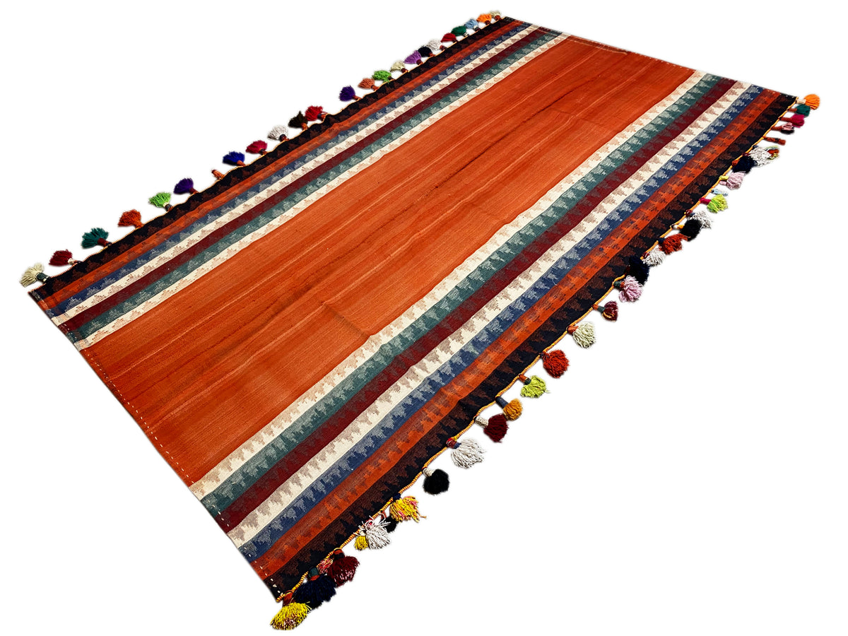 Jajim rug diagonal: terracotta stripes, multicolored border, and tassels at all corners