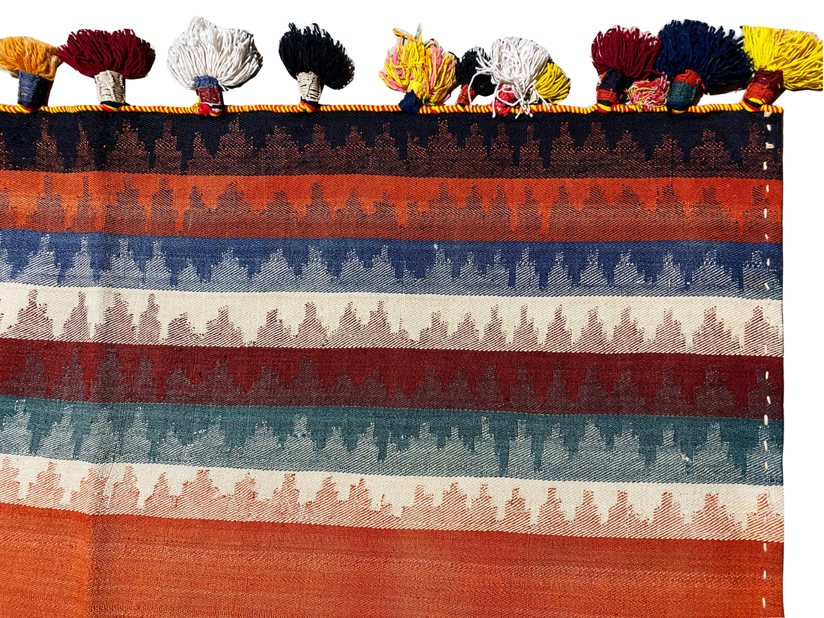 Jajim rug close-up from above: multicolored stripes and tassel fringe along the edge