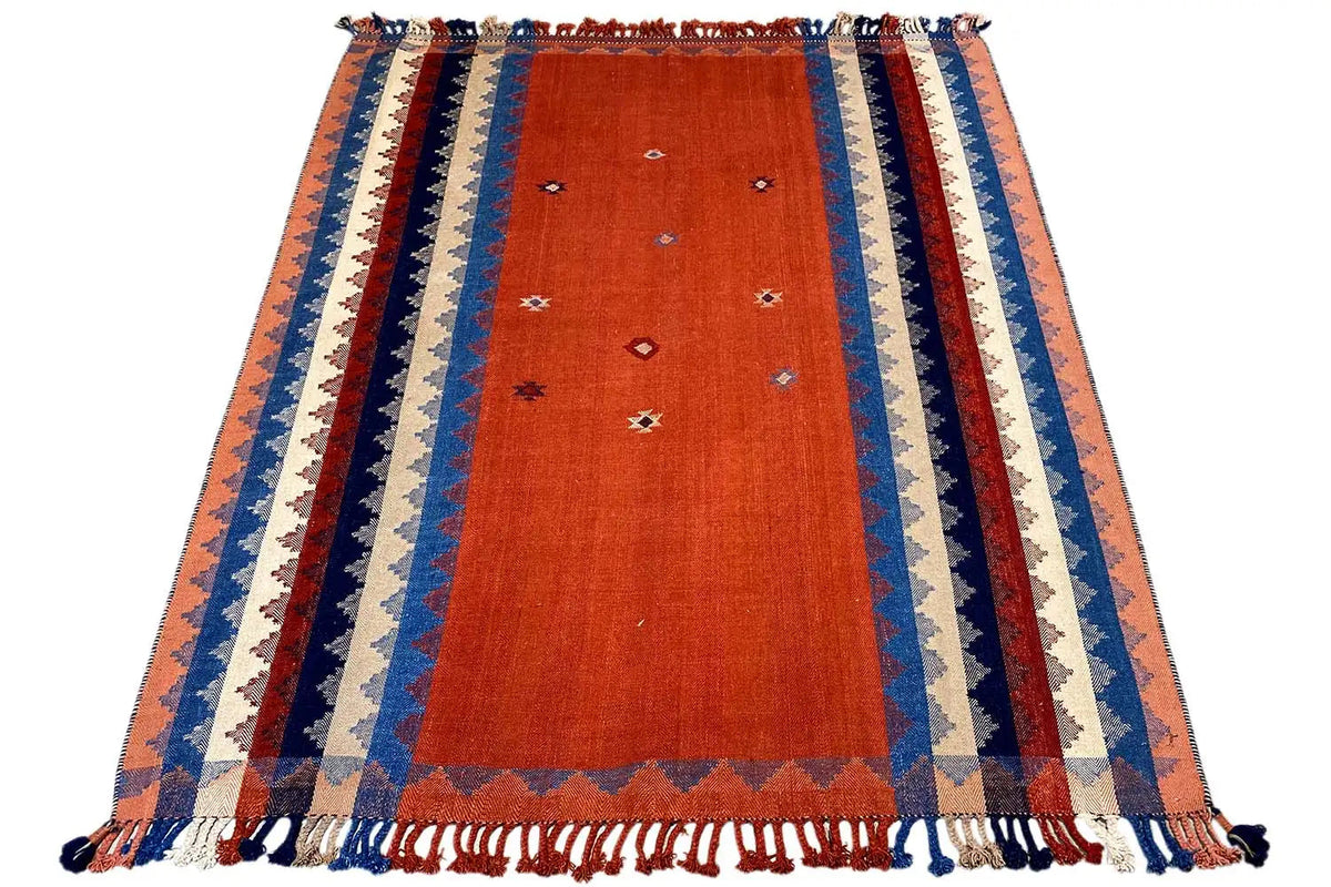Orange rug with blue-and-white decorative stripes and fringes along the edge