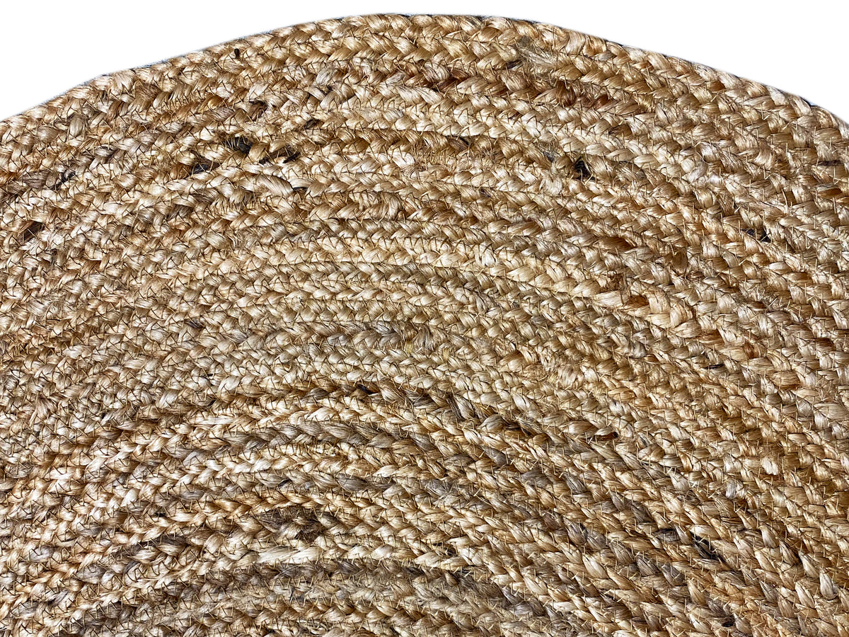 Close-up: beige jute rug with a coarse weave and spiral ring