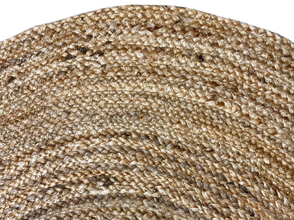 Close-up: beige jute rug with a coarse weave and spiral ring