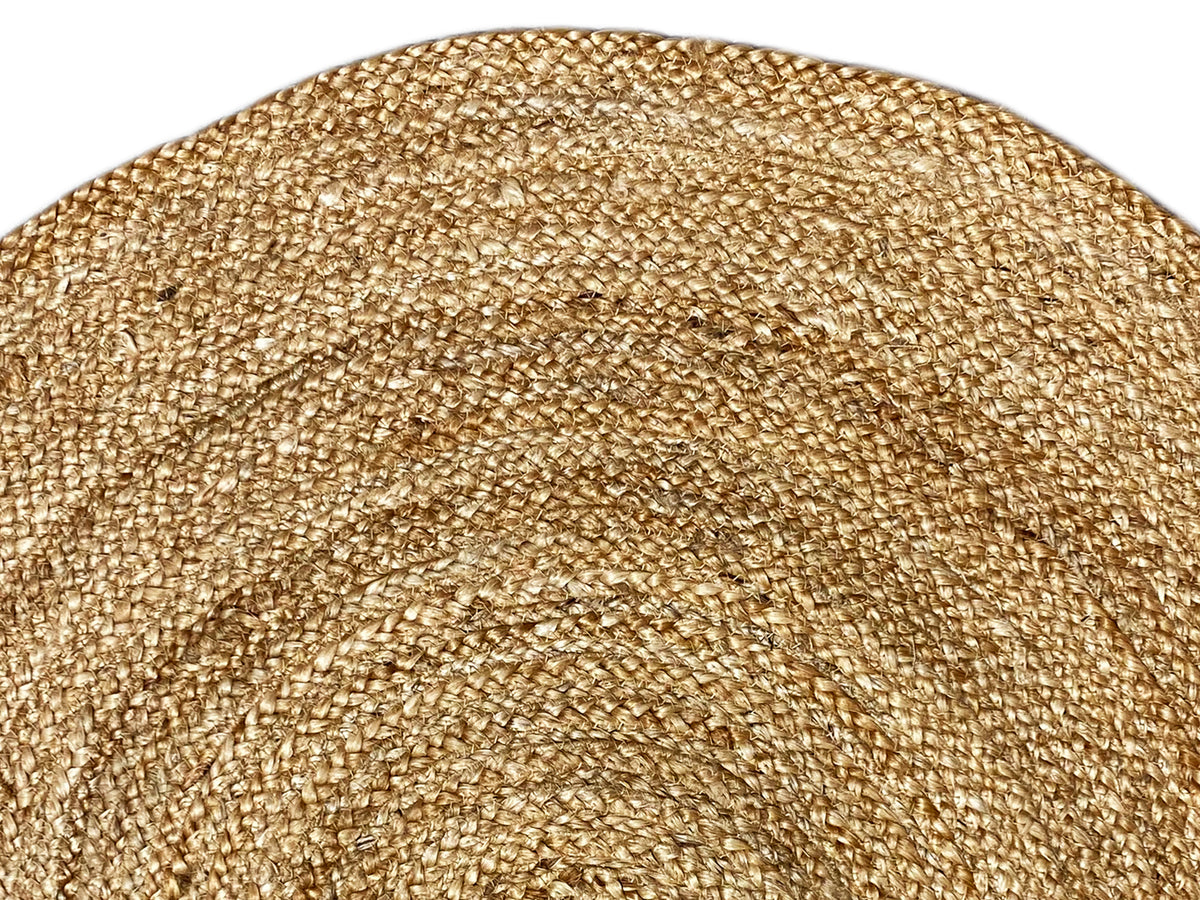 Close-up of a jute rug: golden-beige pile with a fine, dense weave pattern
