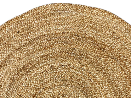 Close-up of a jute rug: golden-beige pile with a fine, dense weave pattern