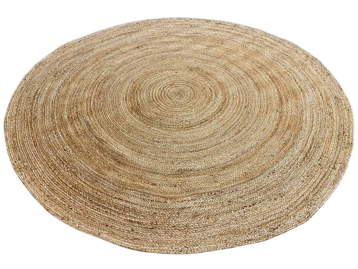 Round jute rug with a beige concentric pattern and fine woven texture