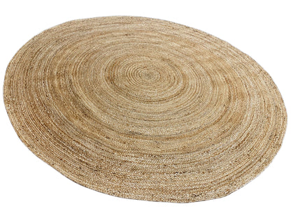 Round jute rug in natural beige with a shimmering spiral design