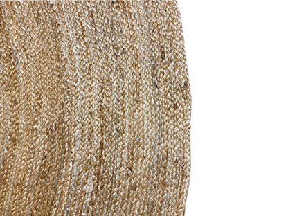 Jute rug edge with a dense, woven texture and light-colored fibers