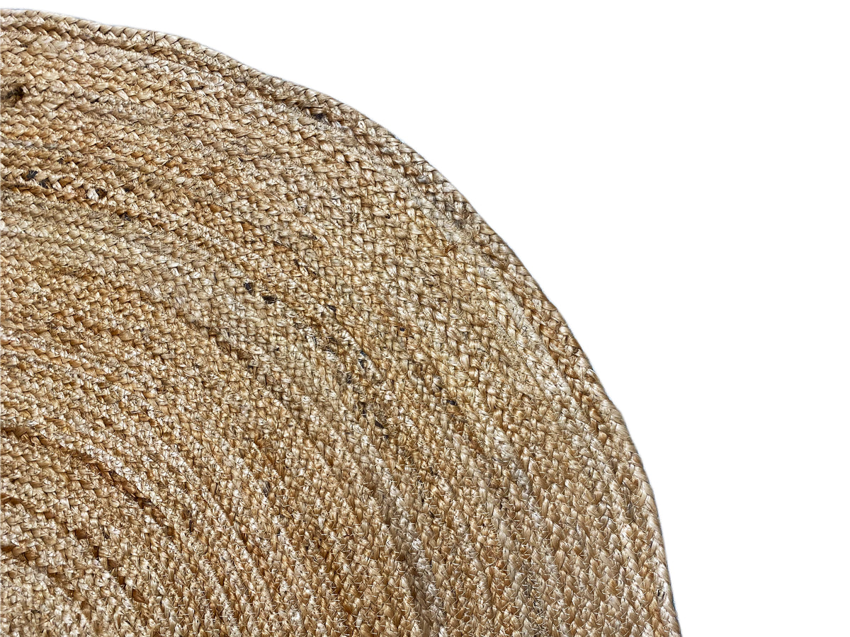 Close-up: jute rug with a spiral texture, coarse woven fabric in beige
