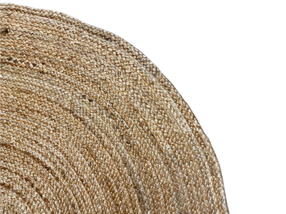 Close-up: jute rug with a spiral texture, coarse woven fabric in beige
