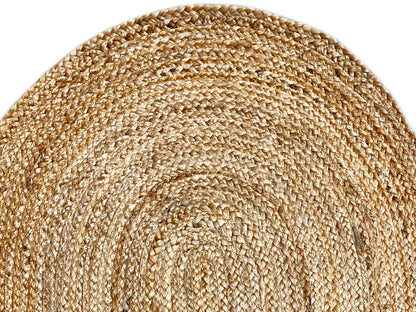 Detail of the jute rug: coarsely woven natural fibers with a spiral pattern line.
