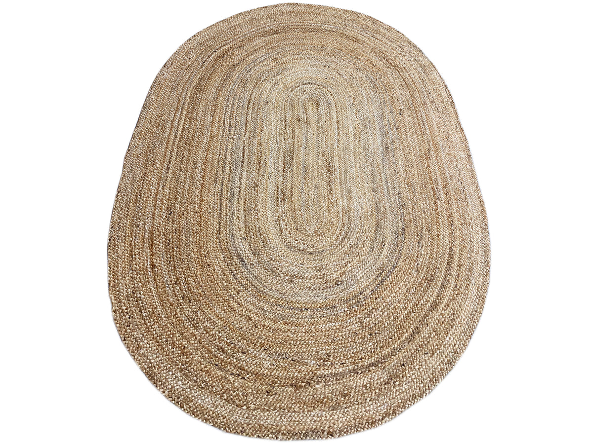 Oval jute rug with a patterned spiral motif in natural beige fiber