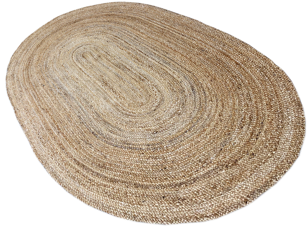 Oval jute rug, light natural fiber with a spiraling pattern