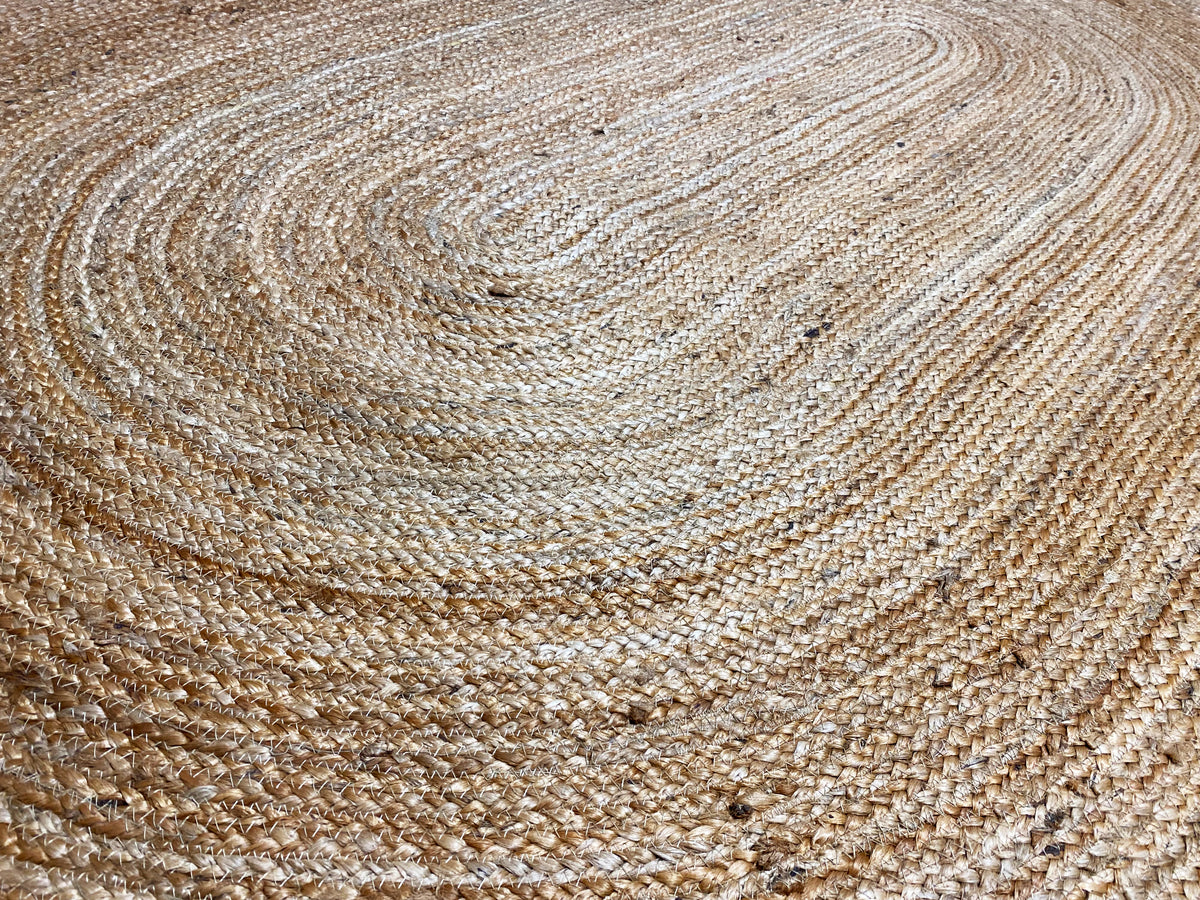 Jute rug surface with a spiral braided pattern, natural-colored and textured