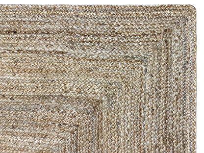 Jute rug close-up: natural beige, tightly woven surface with patterned lines.