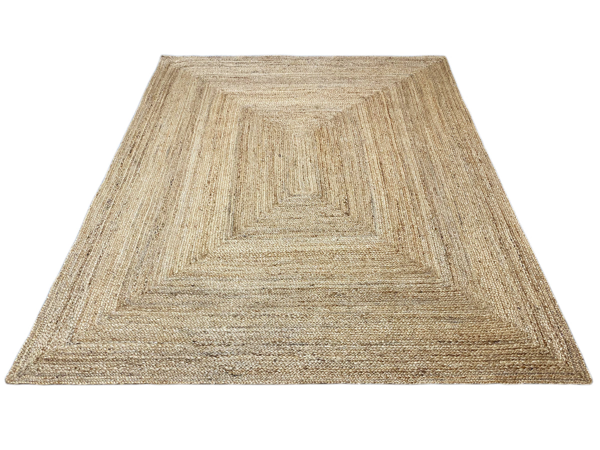Jute rug with geometric pattern, natural beige, mottled texture, clean edges.