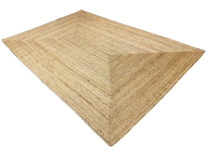 Jute rug with geometric pattern, natural brown, shown at an angle