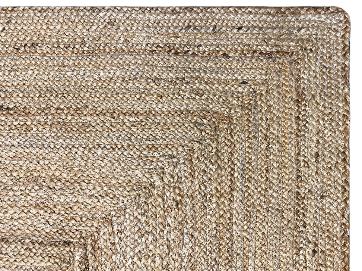 Jute rug edge detail with a dense weave and fine natural-colored threads