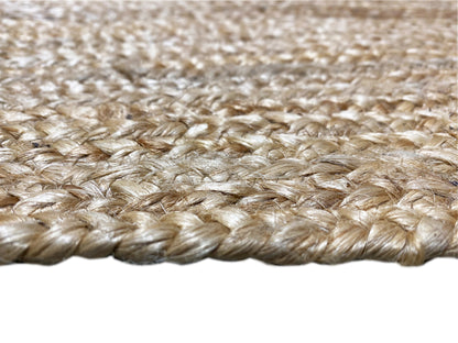 Jute rug edge with short, braided fringes in natural tones