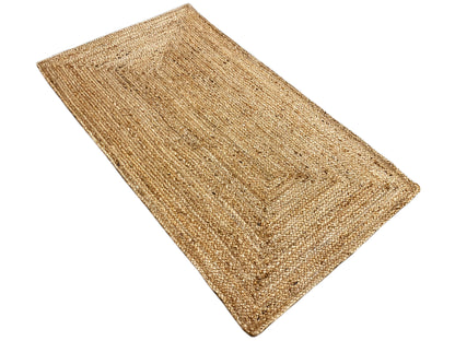 Rectangular jute rug, laid diagonally, natural-colored yarn with a fine texture