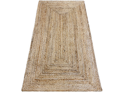 Jute rug angled view, beige weave with a boho border pattern and hemmed edges